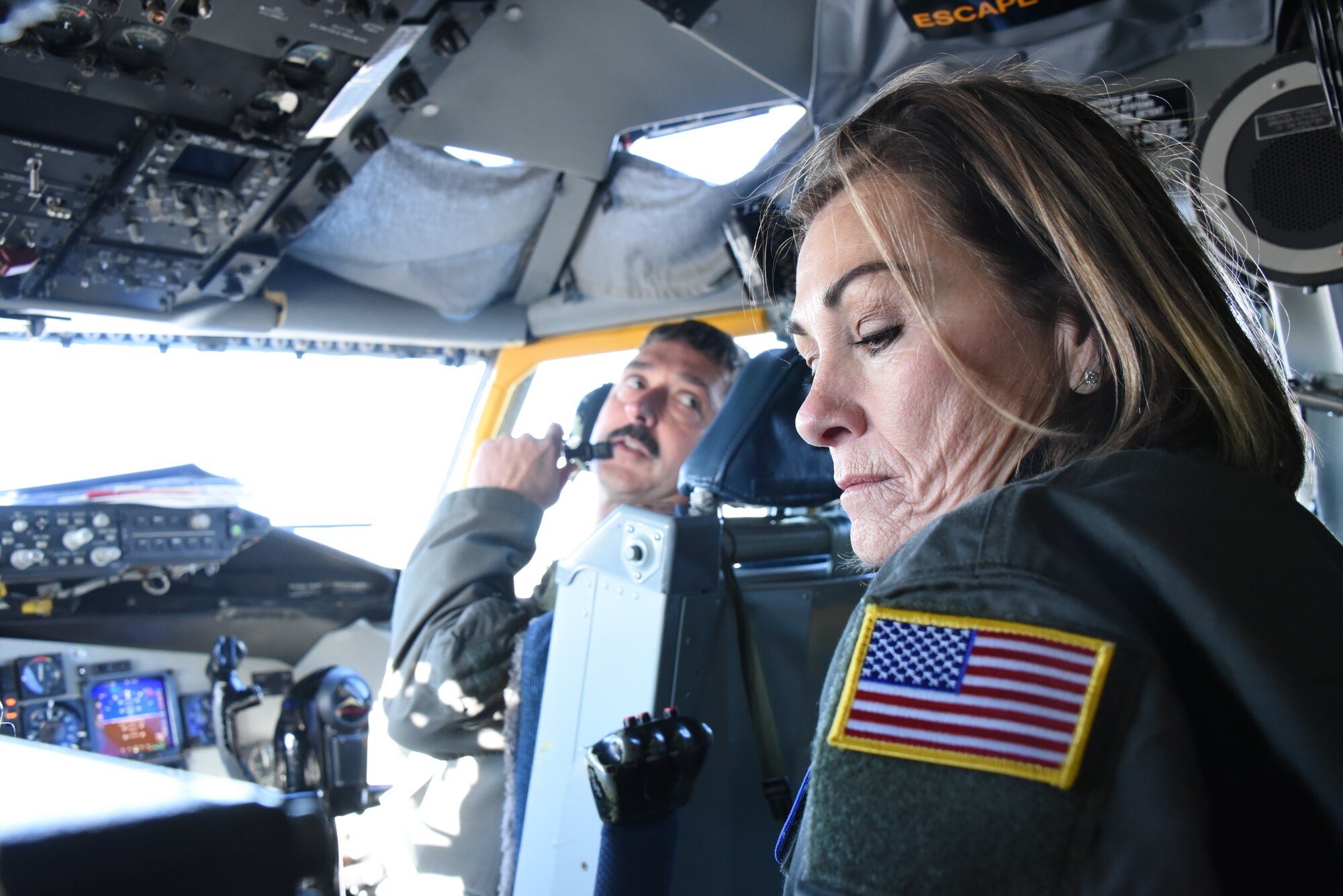 Gov. Kim Reynolds sits in the jump seat of a U.S. Air Force KC-135 Stratotanker