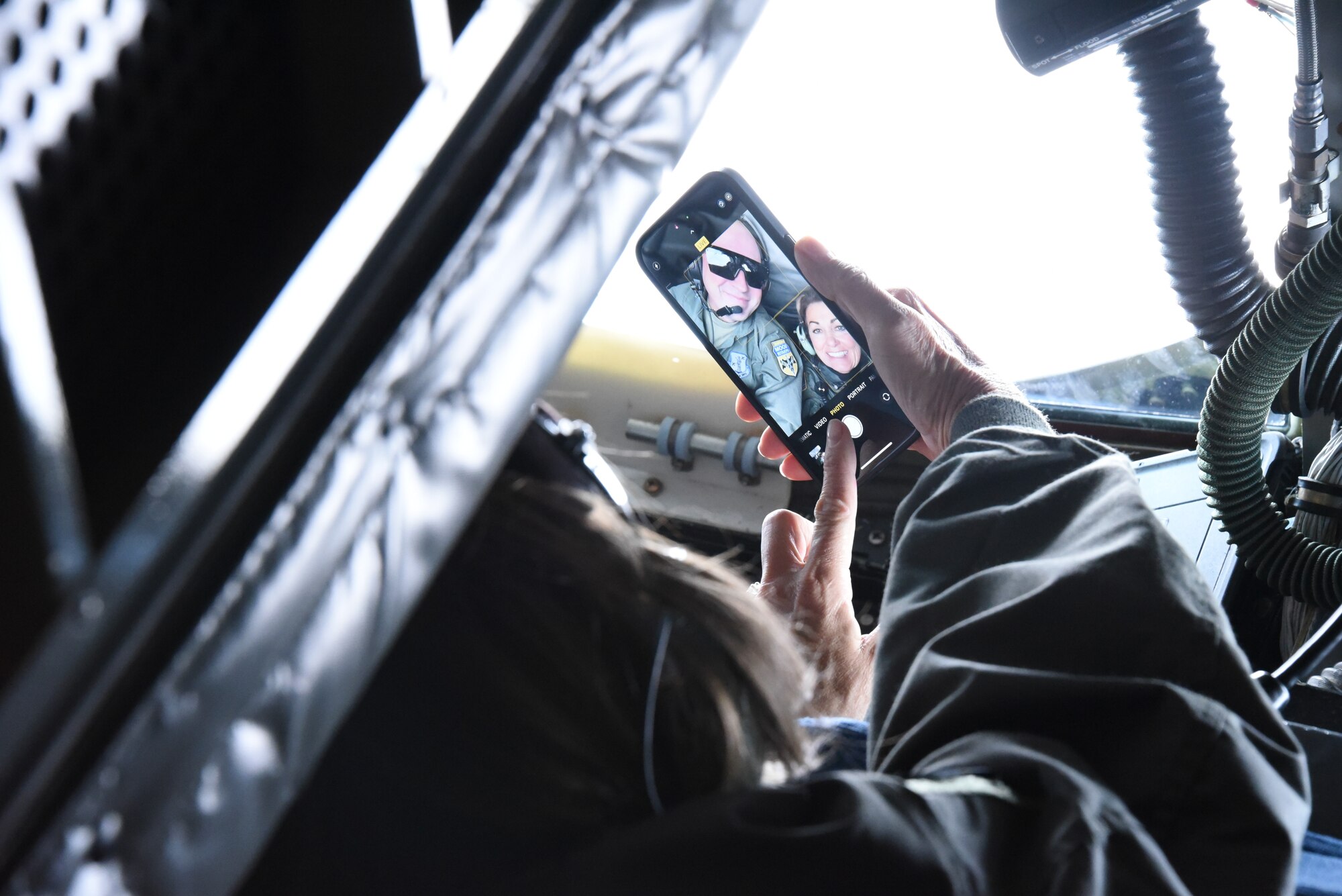 Gov. Kim Reynolds takes a selfie with U.S. Air National Guard Tech. Sgt. Cory Corcoran, a 185th Air Refueling Wing boom operator,