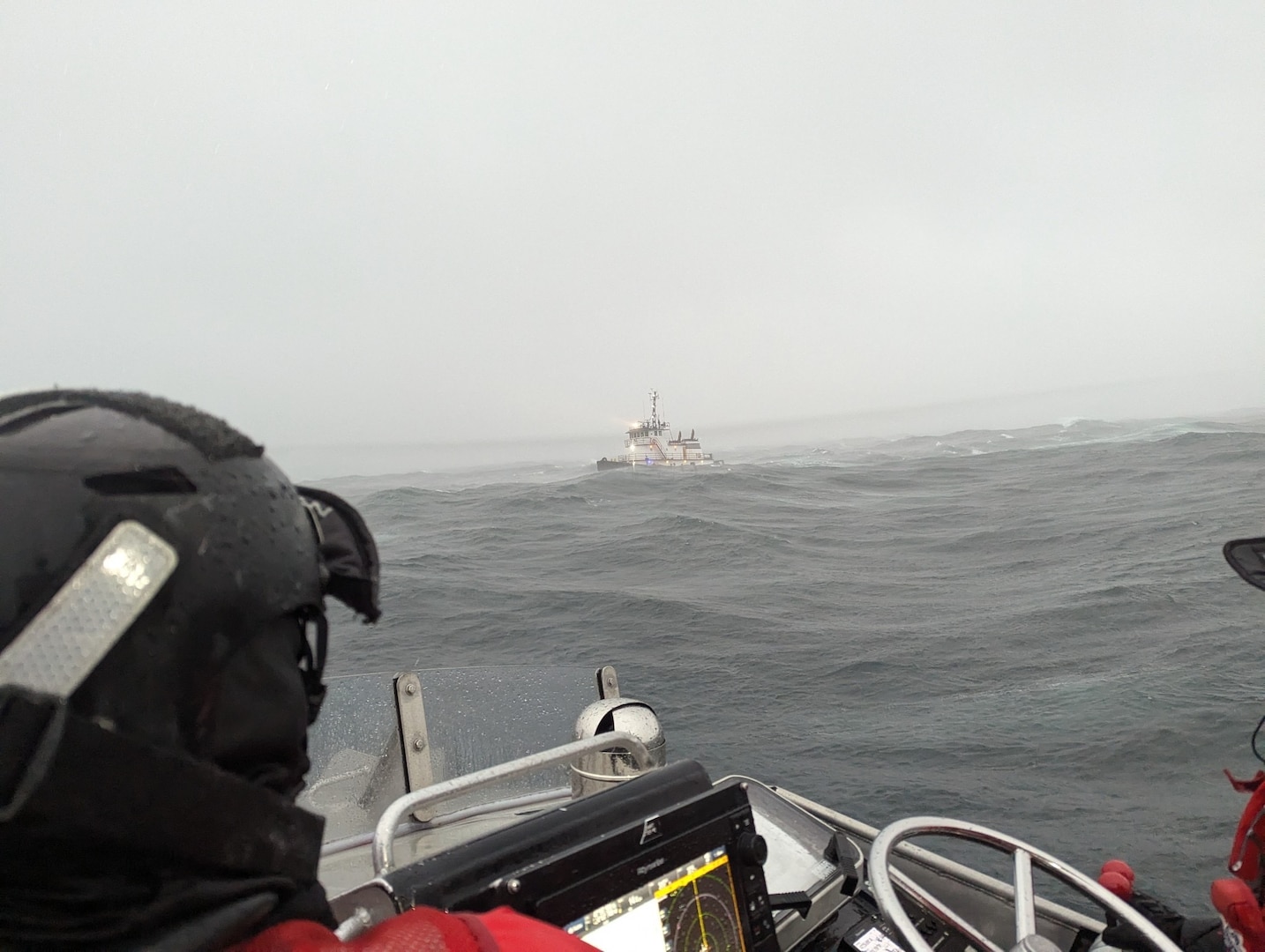 Coast Guard boat crew arrives at search and rescue scene