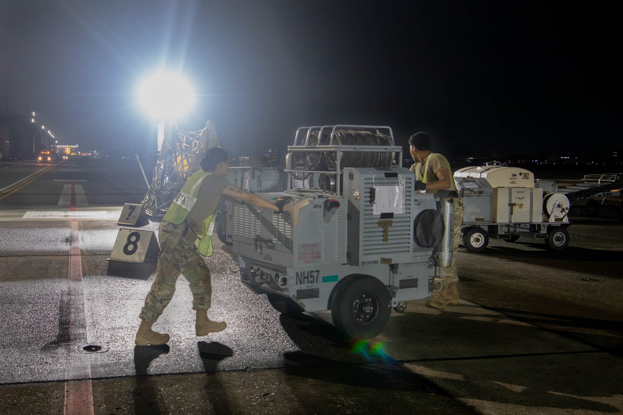 From left, U.S. Air Force Senior Airman Kalyn McCoy, 374th Logistics Readiness Squadron inbound cargo NCO, and Senior Airman Javian Jones, 374th LRS inbound cargo technician, move cargo.