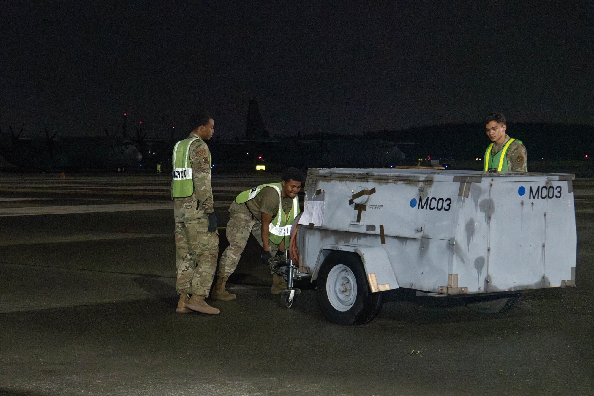 U.S. Air Force Airmen assigned to the 374th Logistics Readiness Squadron move cargo.