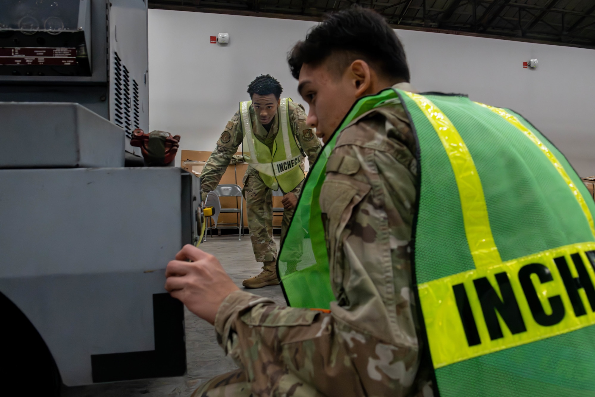 From left, U.S. Air Force Airman 1st Class Juan Huerteto, 374th Logistics Readiness Squadron aircraft parts store apprentice, and Airman Jomarc Arreola, 374th LRS central storage technician, measure cargo.