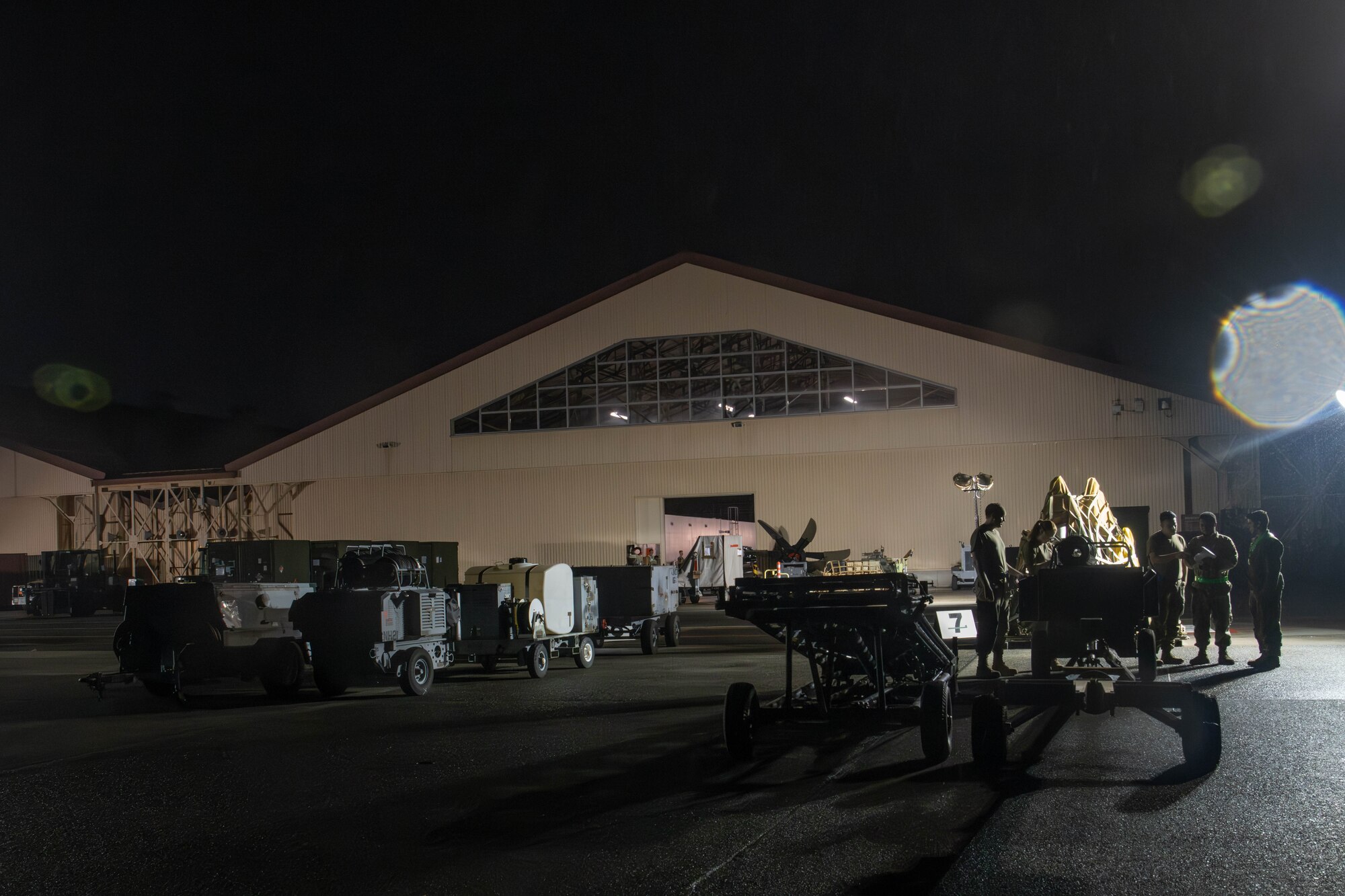 U.S. Air Force Airmen assigned to the 374th Logistics Readiness Squadron stage cargo on the flightline.