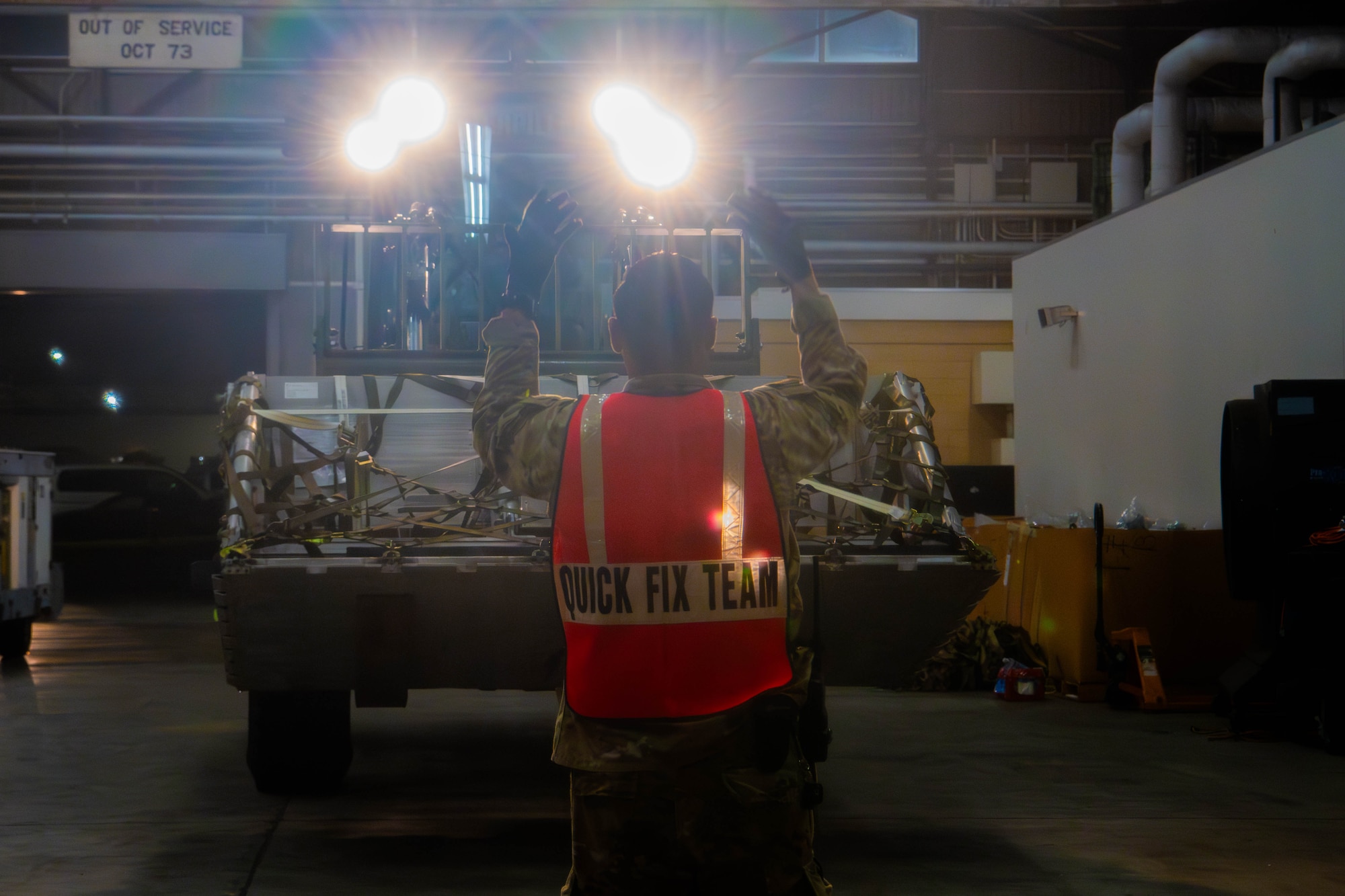 U.S. Air Force Senior Airman Riley Suhr, 374th Logistics Readiness Squadron inbound cargo technician, directs a forklift.