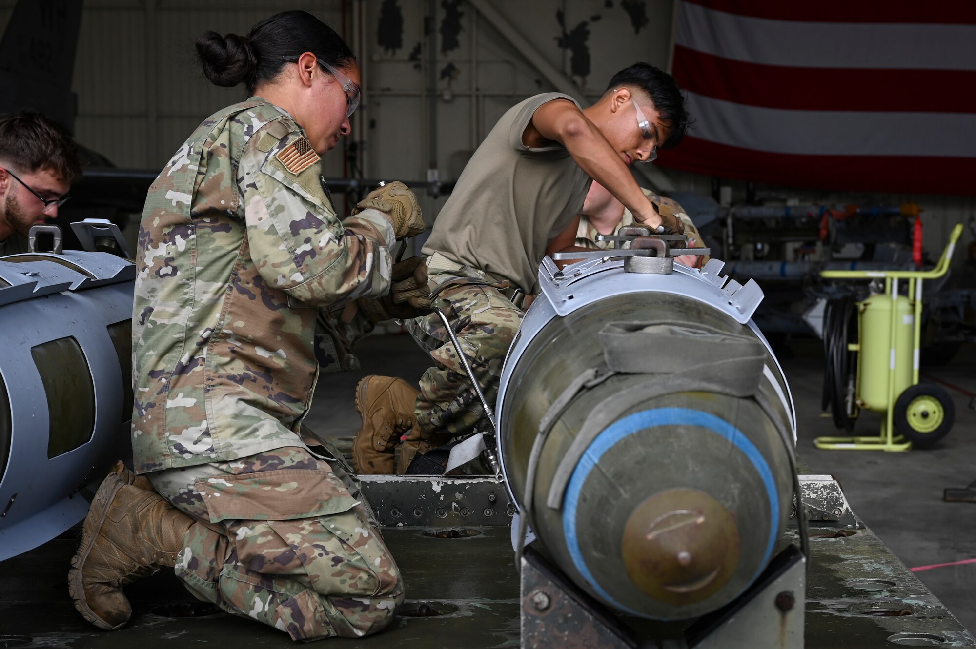 Senior Airman Sarai Perez, left, 8th Maintenance Squadron conventional maintenance crew chief, and Airman 1st Class Anthony Rodriguez Desantiago, 8th MXS conventional maintenance technician, prepare munitions for loading during the 2024 3rd Quarter Dedicated Crew Chief and Load Crew Competition.