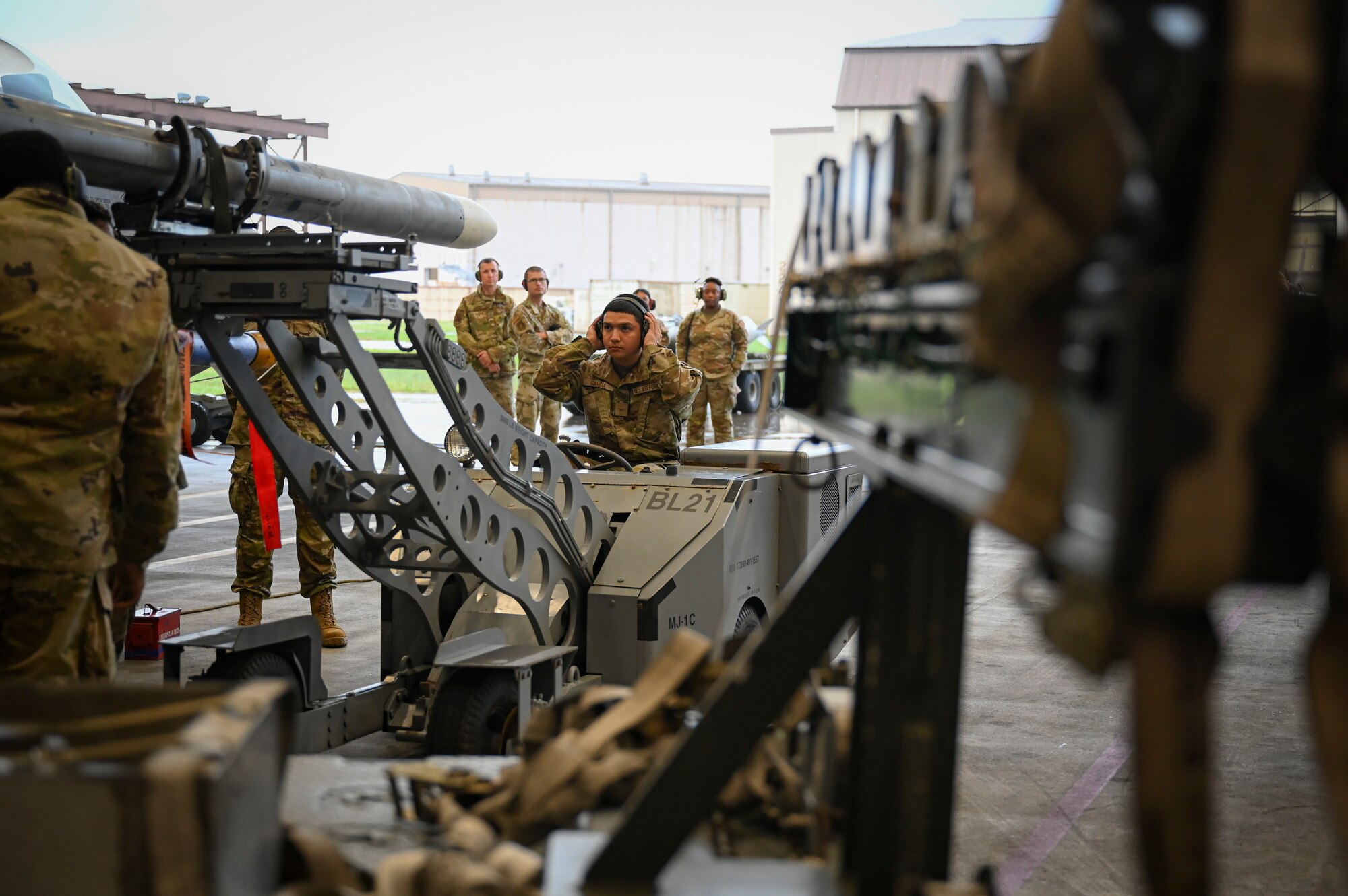 Airman Adrian Garcia, 35th Fighter Generation Squadron weapons load crew, begins to load munitions on an F-16 Fighting Falcon, during the 2024 3rd Quarter Dedicated Crew Chief and Load Crew Competition.