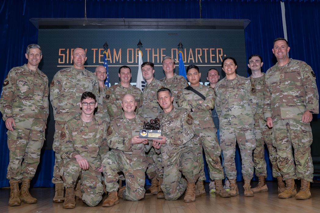 Airmen assigned to the 51st Operations Support Squadron Air Traffic Control Complex receive the Team of the Quarter award during the 51st Fighter Wing third quarter awards ceremony at Osan Air Base, Republic of Korea, Oct. 18, 2024. The Team of the Quarter award  recognizes the office that displayed exemplary performance while executing the wing’s “Fight Tonight” mission. (U.S. Air Force photo by Staff Sgt. Kahdija Slaughter)