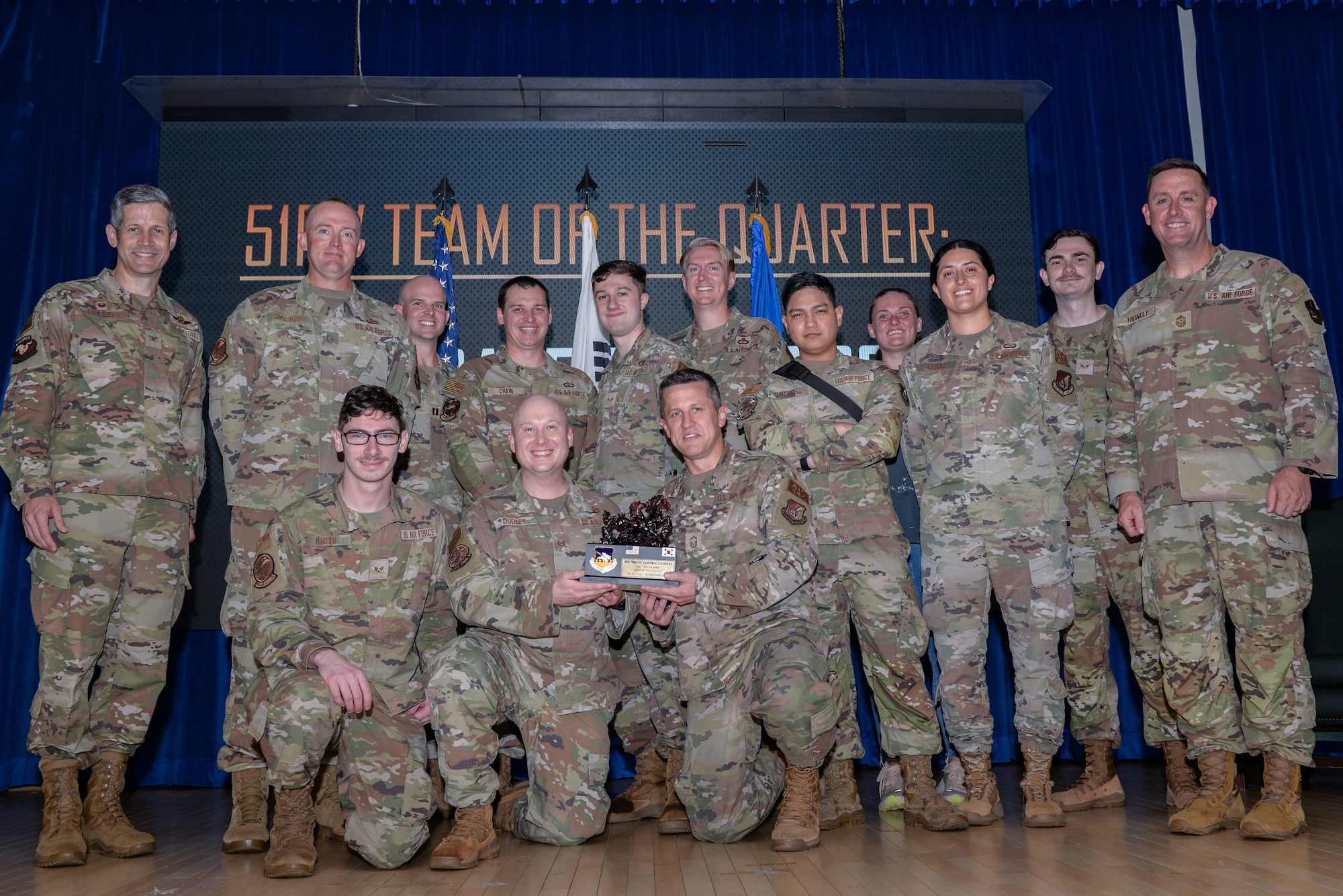 Airmen assigned to the 51st Operations Support Squadron Air Traffic Control Complex receive the Team of the Quarter award during the 51st Fighter Wing third quarter awards ceremony at Osan Air Base, Republic of Korea, Oct. 18, 2024. The Team of the Quarter award  recognizes the office that displayed exemplary performance while executing the wing’s “Fight Tonight” mission. (U.S. Air Force photo by Staff Sgt. Kahdija Slaughter)