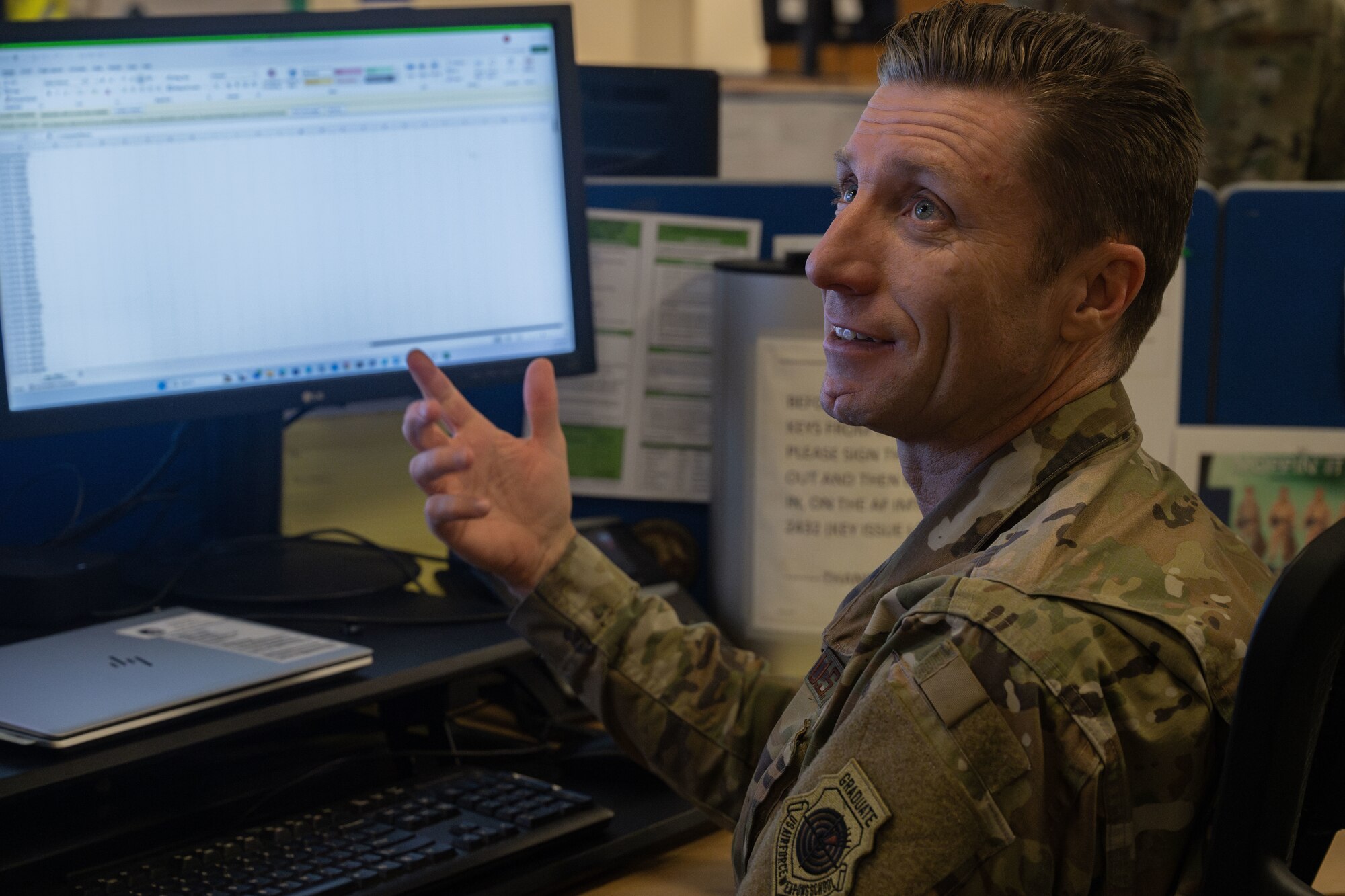 U.S. Air Force Col. Ryan Garlow, 100th Air Refueling Wing commander, asks Airman 1st Class Andrew Simons, 100th Communications Squadron client systems technician, questions regarding the job of a client systems technician during a “Day in the Life” integration with the 100th CS at Royal Air Force Mildenhall, England, Oct. 18, 2024.