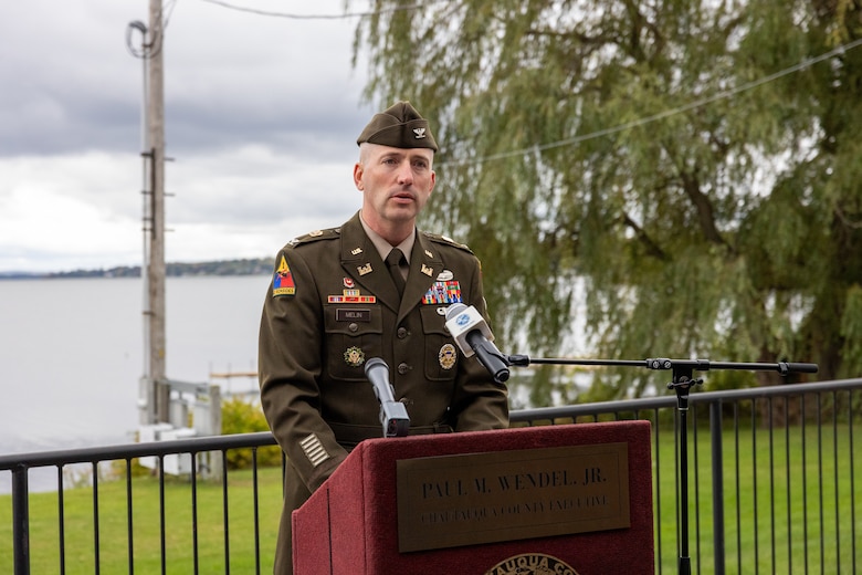 A man speaks at a podium.