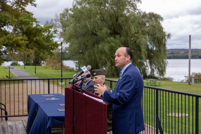 A man speaks at a podium.