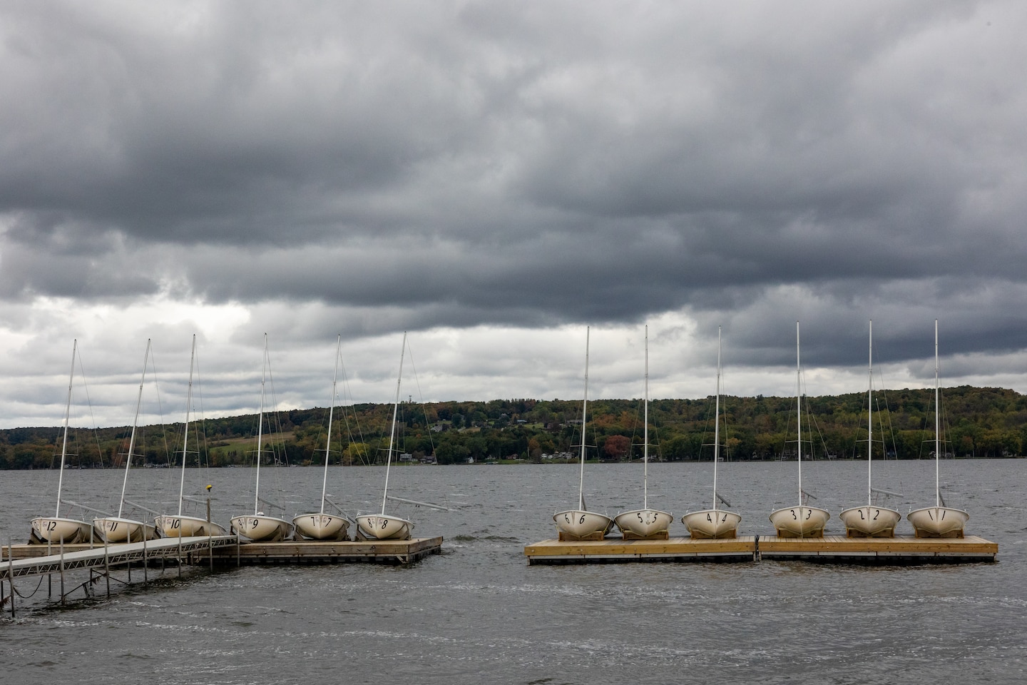 A picture of boats on a dock in a lake.