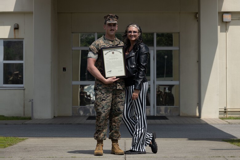 U.S. Marine Corps SSgt. Brenden Kuhlmann, left, poses for a photo with his wife after his promotion ceremony on Camp Hansen, Okinawa, Japan, April 11, 2024. Kuhlmann was meritoriously promoted to staff sergeant for superior performance in his occupational specialty and as recognition of his ability to assume positions of greater authority and responsibility. Kuhlmann, a native of Alaska, is an artillery electronics technician with 12th Marine Littoral Regiment, 3d Marine Division.