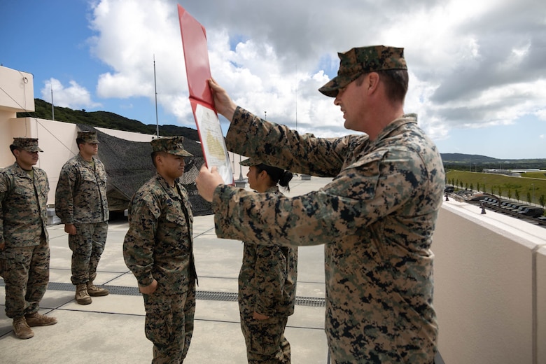 U.S. Marine Corps Staff Sgt. Jack Kemppainen, a transmissions chief with 12th Marine Littoral Regiment, 3d Marine Division reads a promotion warrant while conducting a promotion ceremony during exercise Resolute Dragon 24 at Japan Ground Self-Defense Force Camp Ishigaki, Okinawa, Japan, Aug. 1, 2024. Cpl. Lee is the first Marine to be promoted into the noncommissioned officer ranks on JGSDF Camp Ishigaki. Lee’s responsibilities as a corporal in his military occupational specialty range from ensuring the technical and tactical proficiency of his subordinates to the management of more than $600,000 worth of communications gear. RD 24 is an annual bilateral exercise in Japan that strengthens the command, control, and multi-domain maneuver capabilities of U.S. Marines in III Marine Expeditionary Force and Japan Self-Defense Force personnel, with a focus on controlling and defending key maritime terrain. Kemppainen is a native of Montana. Lee is a native of Alaska.
