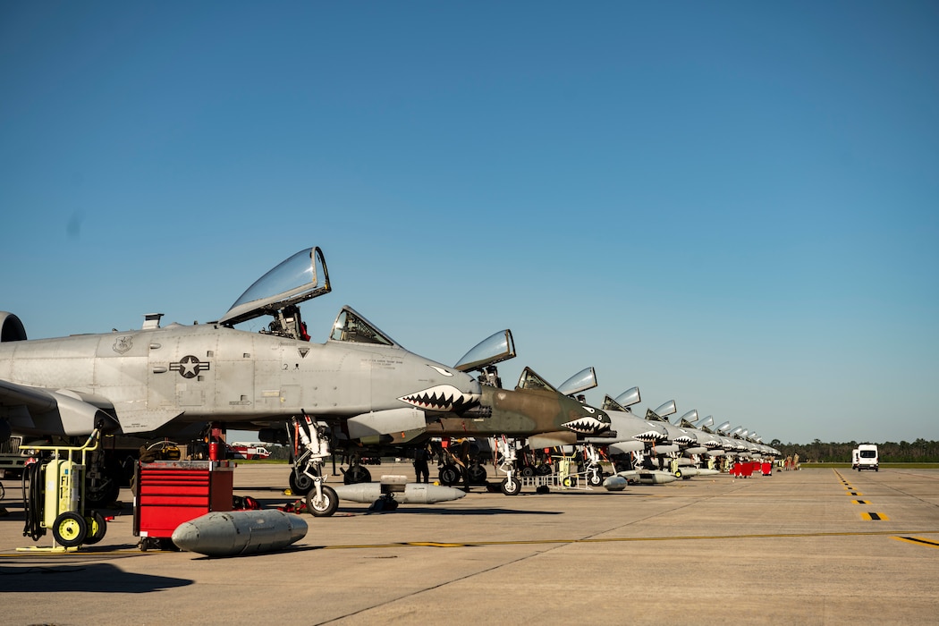 A row of U.S. Air Force A-10C Thunderbolt II aircraft sit on the flight line