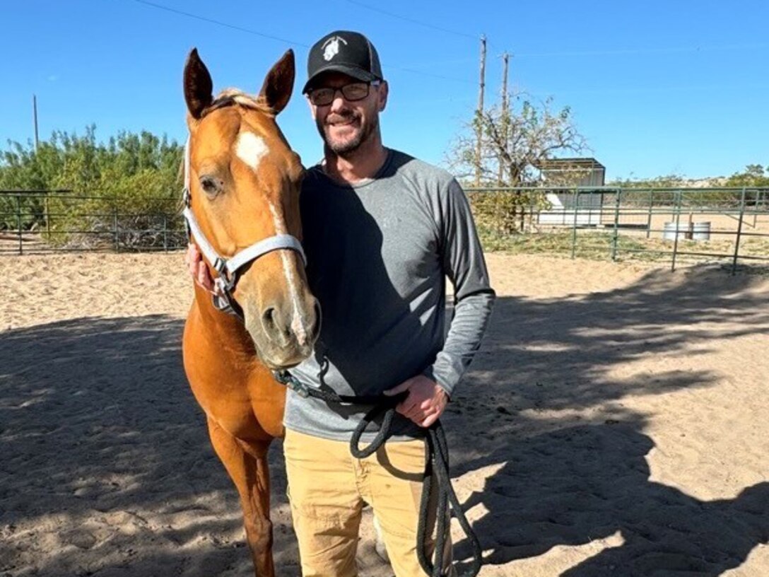 Master Sgt Corey Seeton works with Willow, a ten-year-old quarter horse.