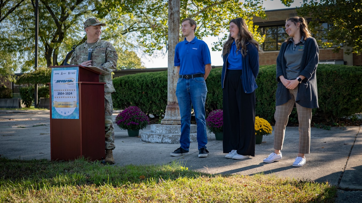 From left: Air Force Research Laboratory Commander Brig. Gen. Jason E. Bartolomei introduces Heidi Kennard, a high school senior at Wayne High School in Huber Heights; Christian Collins, an undergraduate student studying electrical engineering at Wright State University; and Taylor Tyson, an education specialist at the Wright Patterson Air Force Base K-12 Education Outreach Office for AFRL, during the 20th anniversary celebration of the Department of Defense STARBASE Wright-Patt program. The event was held Oct. 4, 2024, at a Child Development Center on Spinning Road in Dayton, Ohio. Each of the former DOD STARBASE Wright-Patt program participants are pursuing a career in science, technology, engineering or math, or STEM. STARBASE Wright-Patt is a K-12 DOD STEM outreach program managed by the Wright-Patterson Air Force Base Education Outreach Office and is primarily focused on fifth-grade students. (U.S. Air Force photo / Keith Lewis)