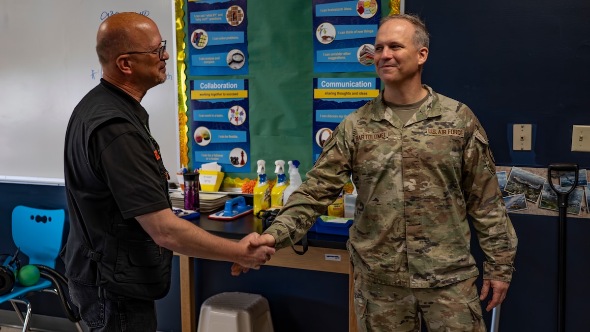 Air Force Research Laboratory Commander Brig. Gen. Jason E. Bartolomei, right, shakes hands with Ian Berry, deputy director of the Department of Defense STARBASE Wright-Patt program, during a facility tour at the program’s a 20th anniversary celebration Oct. 4, 2024, at a Child Development Center on Spinning Road in Dayton, Ohio. STARBASE Wright-Patt is a K-12 DOD science, technology, engineering and math outreach program managed by the Wright-Patterson Air Force Base Education Outreach Office that is primarily focused on fifth-grade students. Since 2003, more than 47,000 students have participated in the DOD Wright-Patt STARBASE program. (U.S. Air Force photo / Keith Lewis)