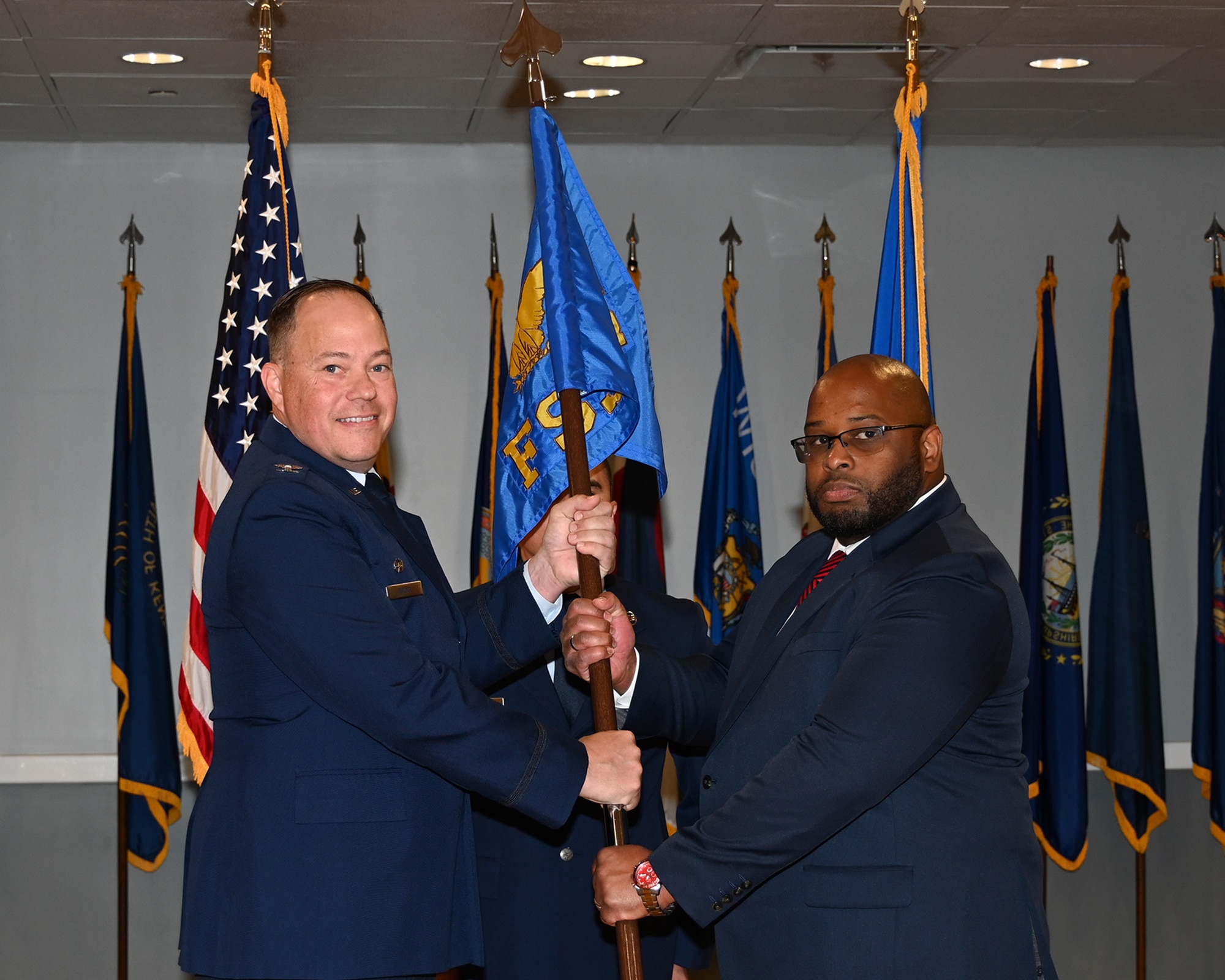 Col. Scott D. Ryder, 14th Mission Support Group commander, presents the 14th Force Support Squadron guidon to Mr. Andre Logan on Columbus Air Force Base, Mississippi, October 18, 2024.