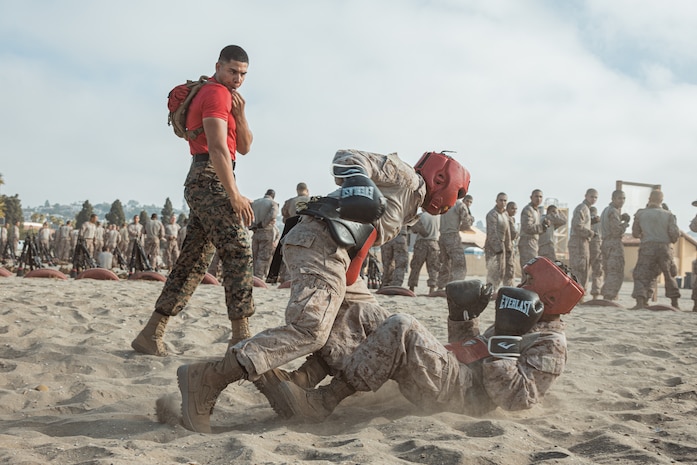U.S. Marine Corps Sgt. Marvin Fuentes, a drill instructor with Alpha Company, 1st Recruit Training Battalion, observes a body sparring event at Marine Corps Recruit Depot San Diego, California, Sept. 30, 2024. Recruits are taught Marine Corps Martial Arts Program techniques that instill basic self-defense that they will execute throughout recruit training during events like body sparring and pugil sticks to help build a warrior ethos and esprit de corps. (U.S. Marine Corps photo by Cpl. Sarah M. Grawcock)