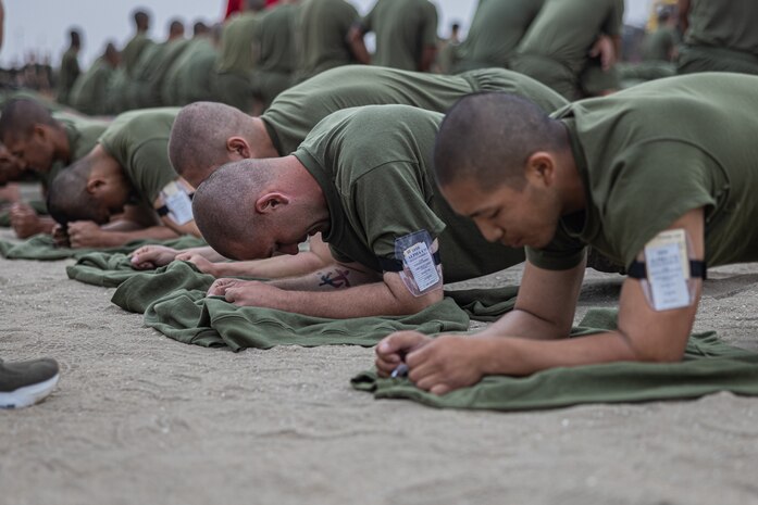 U.S. Marine Corps recruits with Alpha Company, 1st Recruit Training Battalion, execute a plank during a physical fitness test at Marine Corps Recruit Depot San Diego, California, Oct. 7, 2024. The PFT is an evaluation that all recruits must pass and sets the standards all Marines must maintain once a year to assess battle readiness as well as physical conditioning. (U.S. Marine Corps photo by Lance Cpl. Jacob B. Hutchinson)