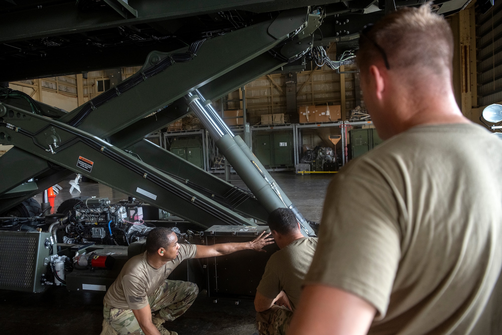 U.S. Air Force Staff Sgt. Maurice Kelly, a vehicle maintenance instructor assigned to the 346th Training Squadron, shows Airmen assigned to multiple vehicle maintenance units, the parts of a Halvorsen 25K Cargo Loader at Muñiz Air National Guard Base, Carolina, Puerto Rico, June 5, 2024.