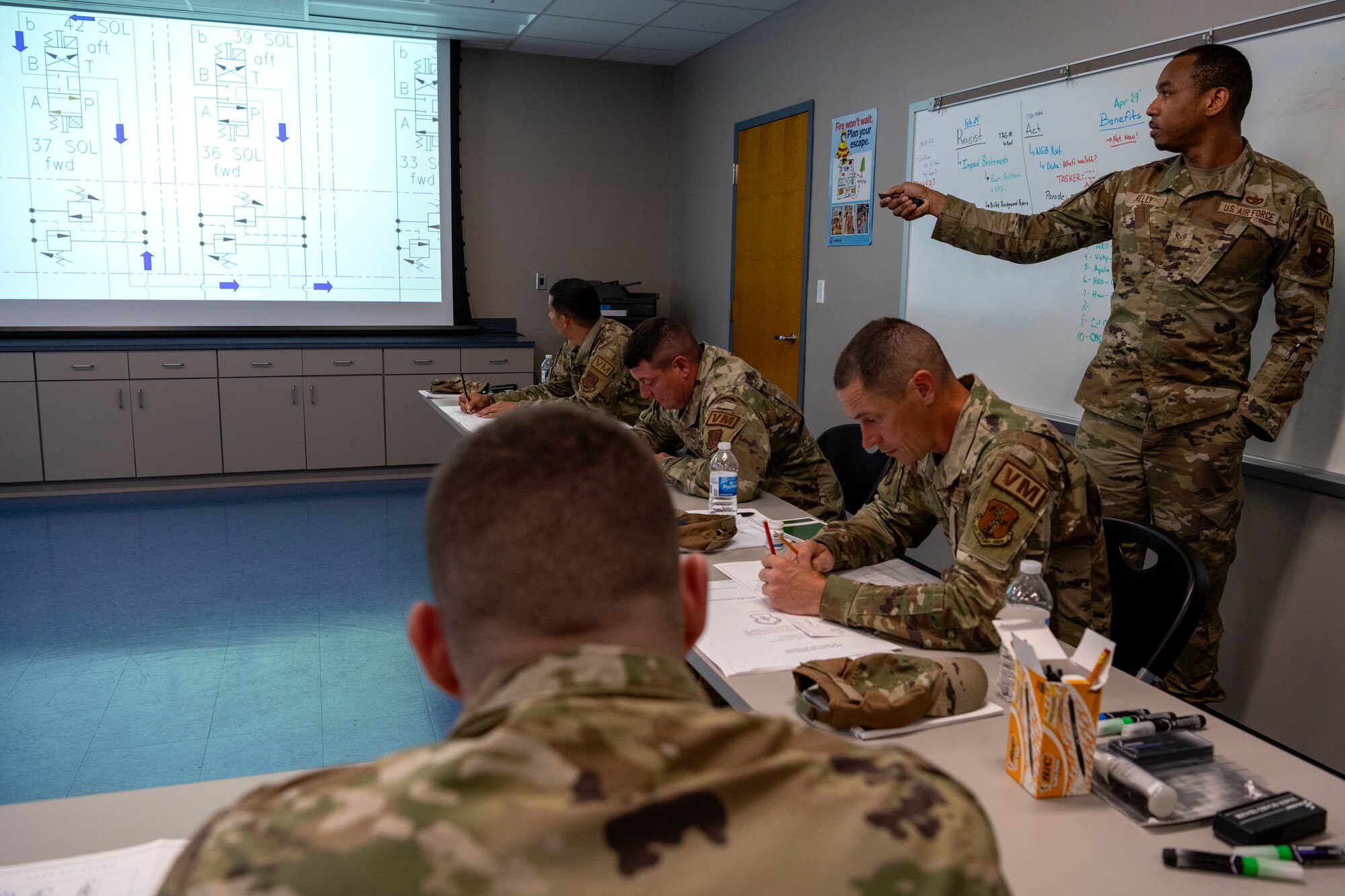 U.S. Air Force Staff Sgt. Maurice Kelly, a vehicle maintenance instructor assigned to the 346th Training Squadron, showcases a diagram for the Halvorsen 25K Cargo Loader to Airmen assigned to multiple vehicle maintenance units, at Muñiz Air National Guard Base, Carolina, Puerto Rico, June 4, 2024.