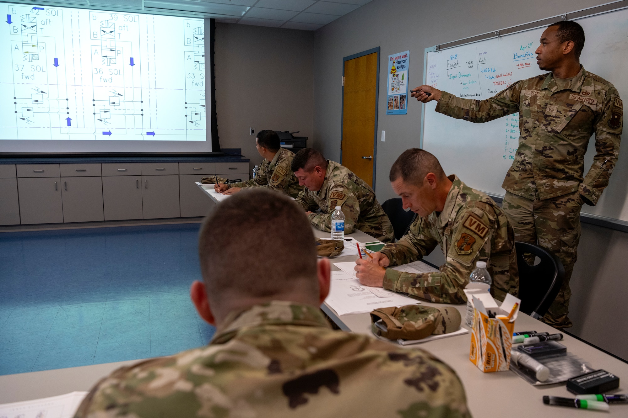 U.S. Air Force Staff Sgt. Maurice Kelly, a vehicle maintenance instructor assigned to the 346th Training Squadron, showcases a diagram for the Halvorsen 25K Cargo Loader to Airmen assigned to multiple vehicle maintenance units, at Muñiz Air National Guard Base, Carolina, Puerto Rico, June 4, 2024.