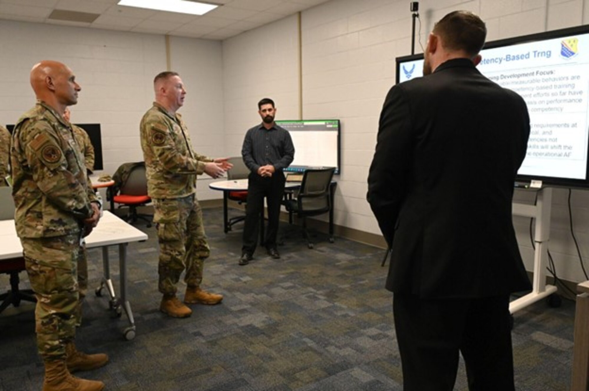 U.S. Air Force Lt. Gen. Brian Robinson, commander of the Air Education and Training Command, and Chief Master Sgt. Chad Bickley, AETC command chief, discuss upgrades to curriculum for Airmen in Training with the 82nd Training Support Squadron