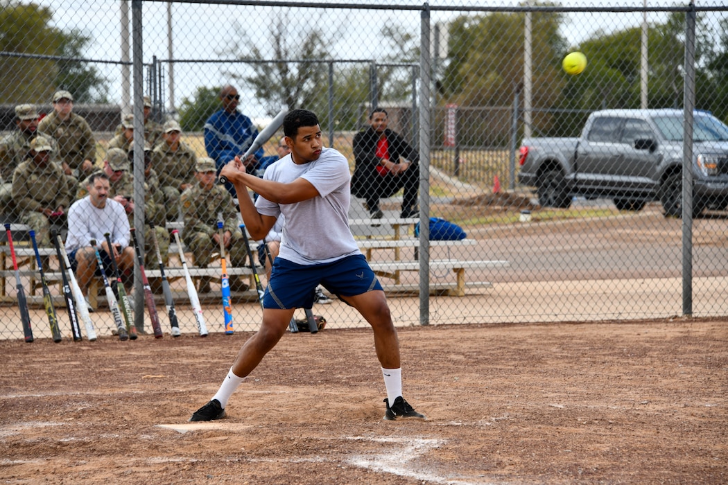 U.S. Air Force Senior Airman Francisco Sosa, 97th Logistics Readiness Squadron inspections journeyman, prepares to hit a softball during the97th Mission Support Group sports day event at Altus Air Force Base, Oklahoma, Oct. 18, 2024. Each player received a total of 12 hits and the player with the most home runs won the home run derby competition. (U.S. Air Force photo by Senior Airman Miyah Gray)