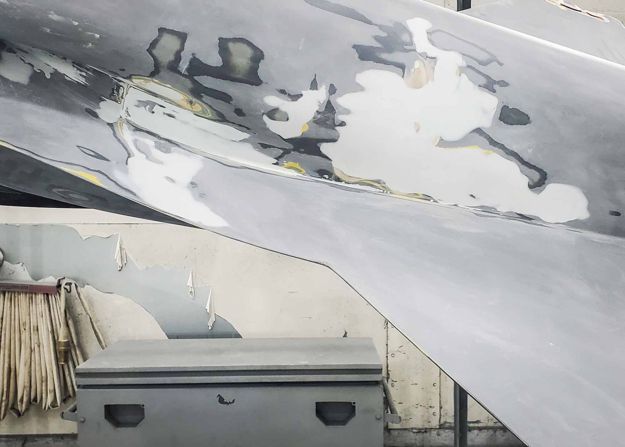 The lower section of the F-16 static display undergoes surface repairs at Luke Air Force Base, Ariz., August 23, 2024. Cracks, chips, and other forms of damage were filled and smoothed in preparation for repainting. (Contributed photo)
