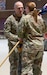 Alaska Army National Guard Lt. Col. Luke Bushatz, left, outgoing commander for the 1st Battalion, 297th Infantry Regiment, passes the colors to Col. Michele Edwards, the commander of the 297th Regional Support Group, as part of a change of command ceremony on Oct. 20, 2024, at Joint Base Elmendorf-Richardson, Alaska. Bushatz served as the battalion commander for the infantry battalion for two years and led his Soldiers through numerous high-demand training events. (Alaska Army National Guard photo by Sgt. Marc Marmeto)