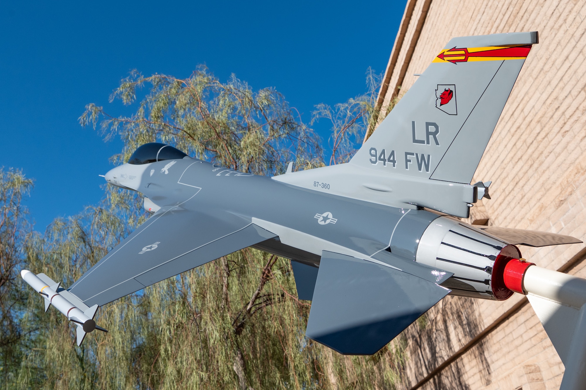 A close-up of the restored F-16 static display outside 944th Fighter Wing headquarters at Luke Air Force Base, Ariz., Oct. 17, 2024, highlights the precision of the restoration work. The display is a tribute to the wing’s past and present members and the heritage of the Hellions. (U.S. Air Force photo by Tech. Sgt. Tyler J. Bolken)