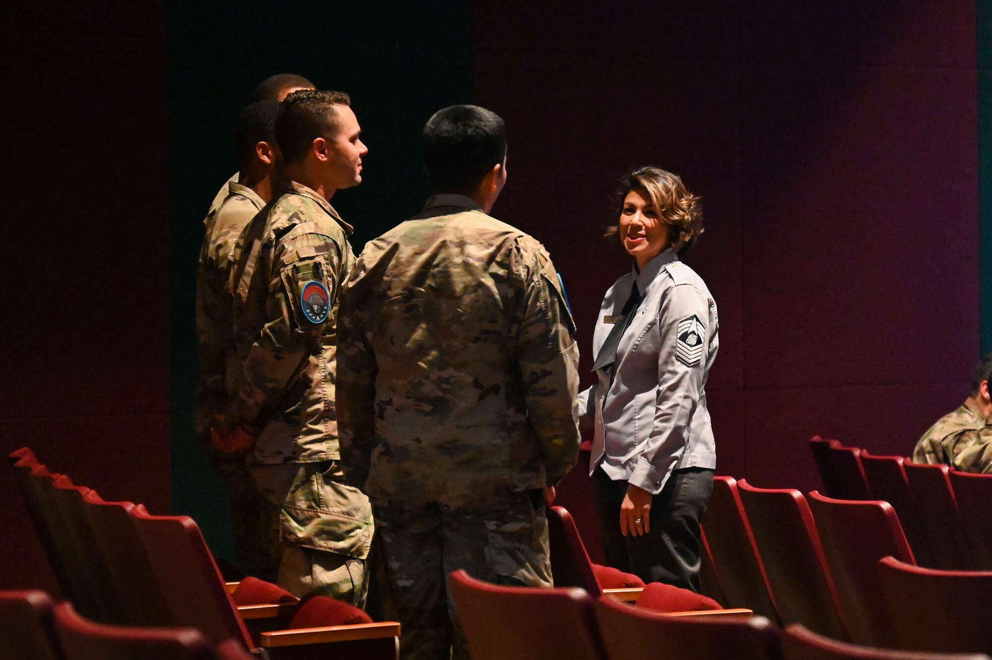People talk in a theater.
