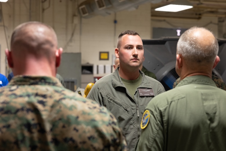 U.S Marine Corps Staff Sgt. Nicholas Bevan, center, airframes mechanic, MALS-13, 3rd MAW gets award at Marine Corps Air Station Yuma, Arizona, Oct. 9, 2024. Bevan received the Navy and Marine Corps Achievement Medal (NAM) for designing a 3D printable maintenance tool that will be used to help maintain aircrafts for years to come.  (U.S. Marine Corps photo by Lance Cpl. Elizabeth Gallagher)