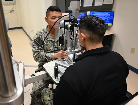 Beaufort S.C.- Lt. Richard Wan is working with his equipment to examine an active duty sailor.