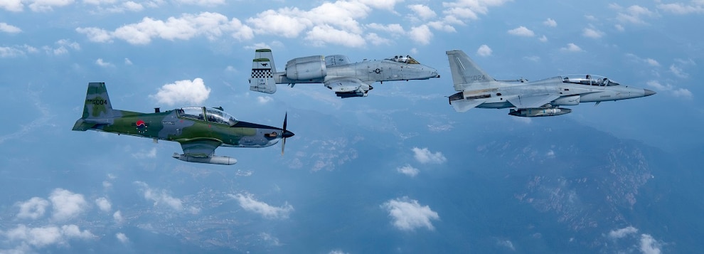 A Republic of Korea Air Force FA-50 Golden Eagle, right, and KA-1 Woongbi, left, assigned to the ROKAF 8th Fighter Wing train with an A-10 Thunderbolt II, center, assigned to the 25th Fighter Squadron during a Buddy Squadron 25-1 flight over Osan Air Base, ROK, Oct. 16, 2024.