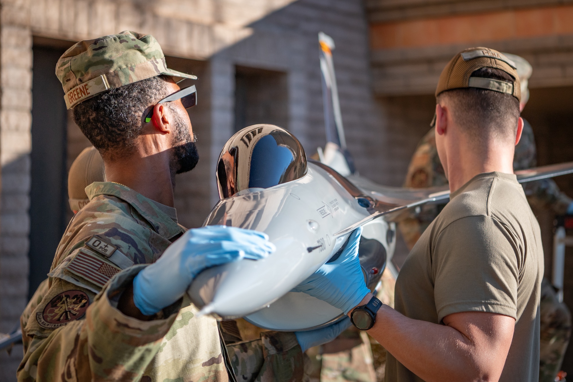 944th Maintenance Group Airmen hold the restored F-16 static display as it is mounted outside the 944th Fighter Wing headquarters at Luke Air Force Base, Ariz., Oct. 17, 2024. The restoration team, led by Airmen like Tech. Sgt. Gabriel Blomfield, dedicated over 80 hours of work to revitalize the display. (U.S. Air Force photo by Tech. Sgt. Tyler J. Bolken)