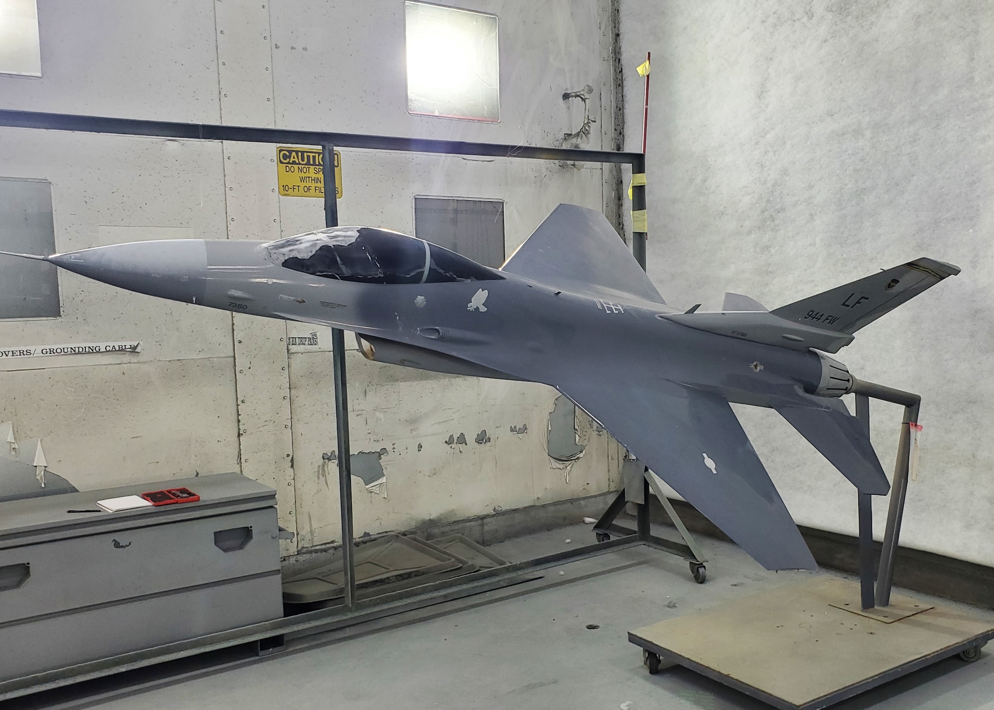 The F-16 static display rests in the 944th Maintenance Squadron's shop at Luke Air Force Base, Ariz., August 3, 2024. The aircraft showed signs of significant wear and damage after being exposed to the elements, prompting the extensive refurbishment project. (Contributed photo)