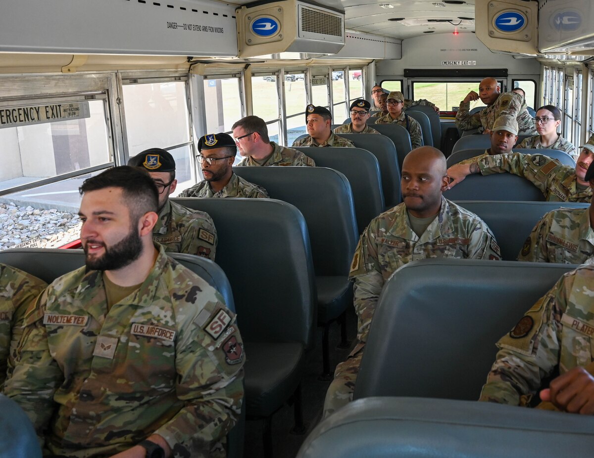 Members of the 17th Training Wing board busses transporting them to their notional deployed environment at the Vance Deployment Center, Goodfellow Air Force Base, Texas, Oct. 17, 2024. The exercise is meant to provide a sense of familiarity to the staff and deployers so the 17th TRW can be prepared to rapidly send and be sent anywhere on the globe. (U.S. Air Force photo by Senior Airman Zach Heimbuch)