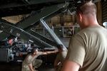 U.S. Air Force Staff Sgt. Maurice Kelly, a vehicle maintenance instructor assigned to the 346th Training Squadron, shows Airmen assigned to multiple vehicle maintenance units, the parts of a Halvorsen 25K Cargo Loader at Muñiz Air National Guard Base, Carolina, Puerto Rico, June 5, 2024.