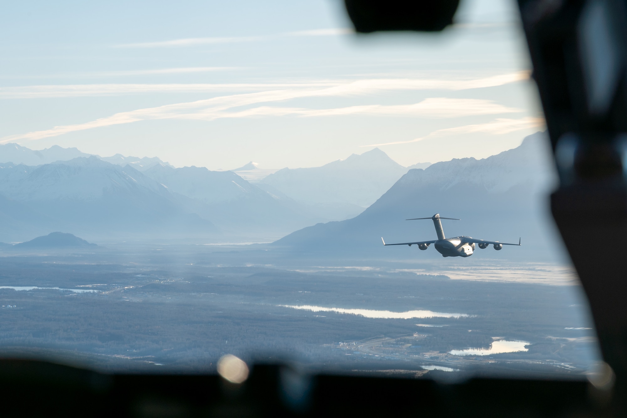 Four U.S. Air Force C-17 Globemaster IIIs fly in formation over Alaska as part of Joint Forcible Entry training, Oct. 15, 2024.