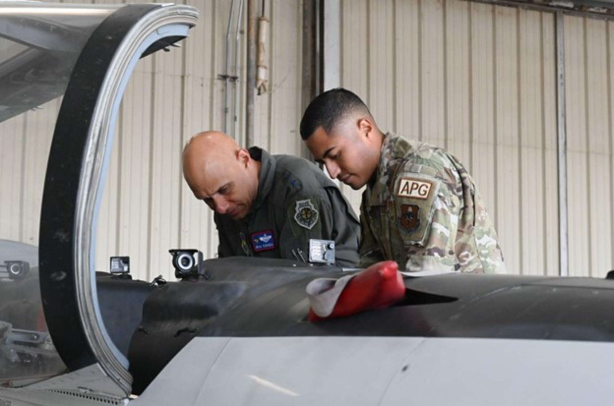 U.S. Air Force Lt. Gen. Brian Robinson, commander of Air Education and Training Command, receives an update from Tech. Sgt. Manuel Jimenez, 80th Flying Training Wing quality assurance inspector