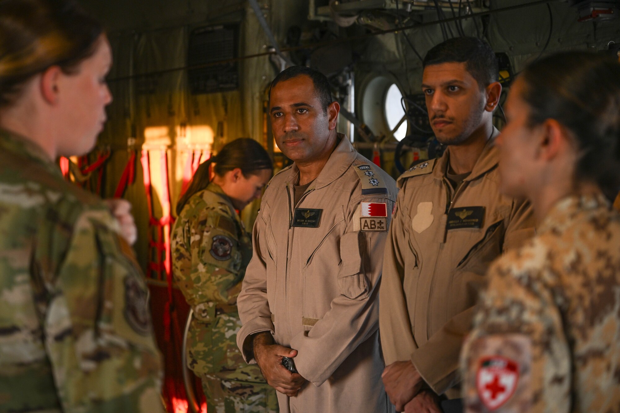 People stand in a group inside an aircraft.