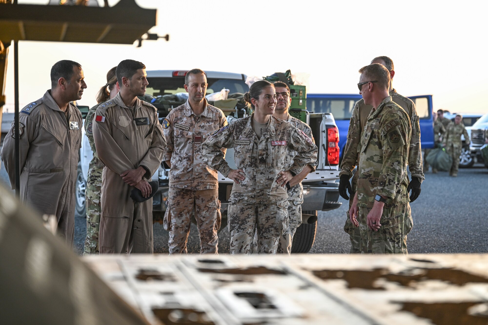 People stand in a group outside of an aircraft.