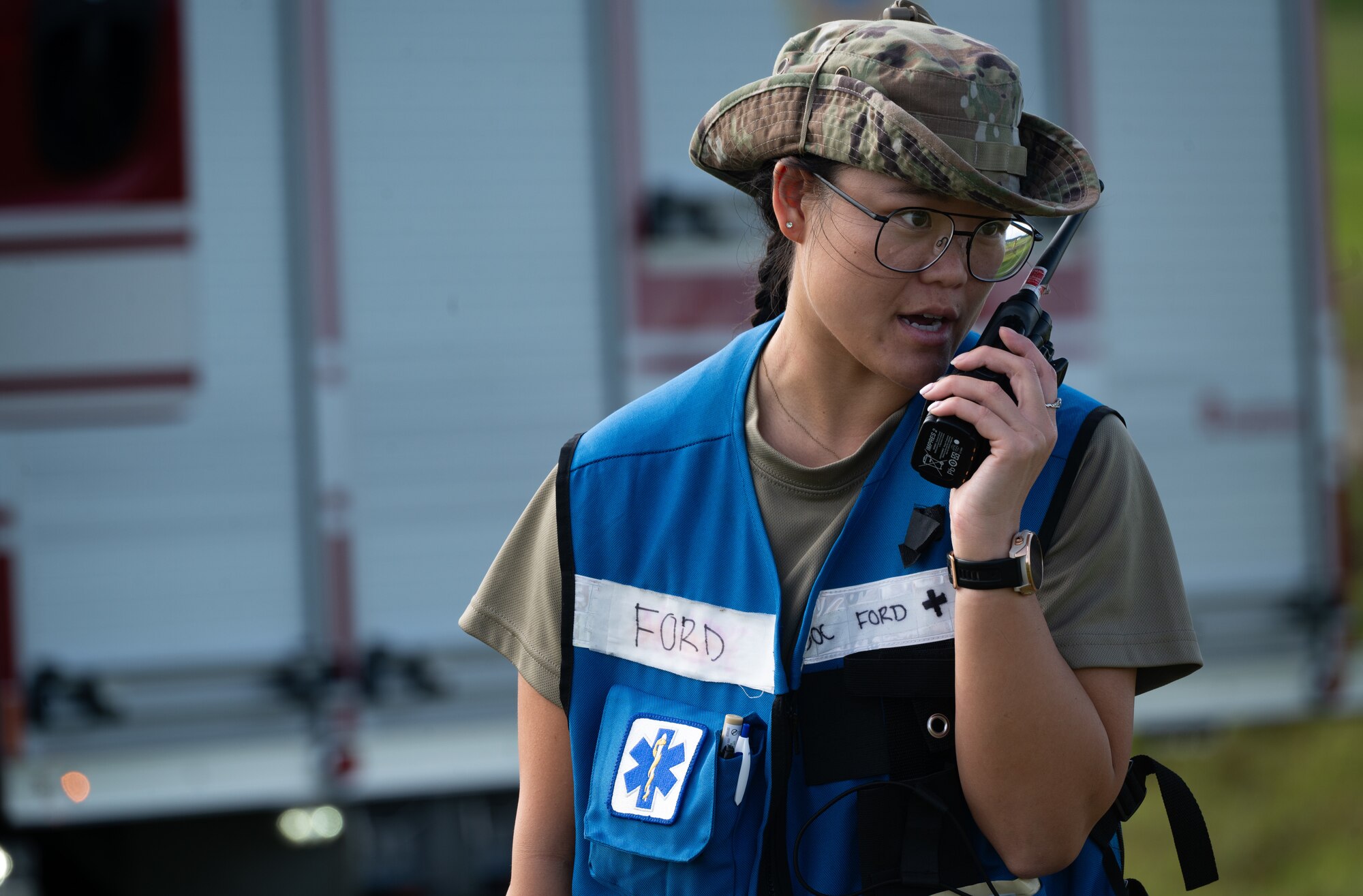 A 36th Medical Group Airman communicates over a radio during a major accident response exercise (MARE) for Slingstone 24-4 at Andersen Air Force Base, Guam, Oct. 22, 2024. The MARE allows first responders to hone the skills needed should a real accident happen. This scenario included a simulated plane fire and passengers scattered around with various injuries, something that would be possible should a real world attack happen. (U.S. Air Force photo by Staff Sgt. Pedro Tenorio)