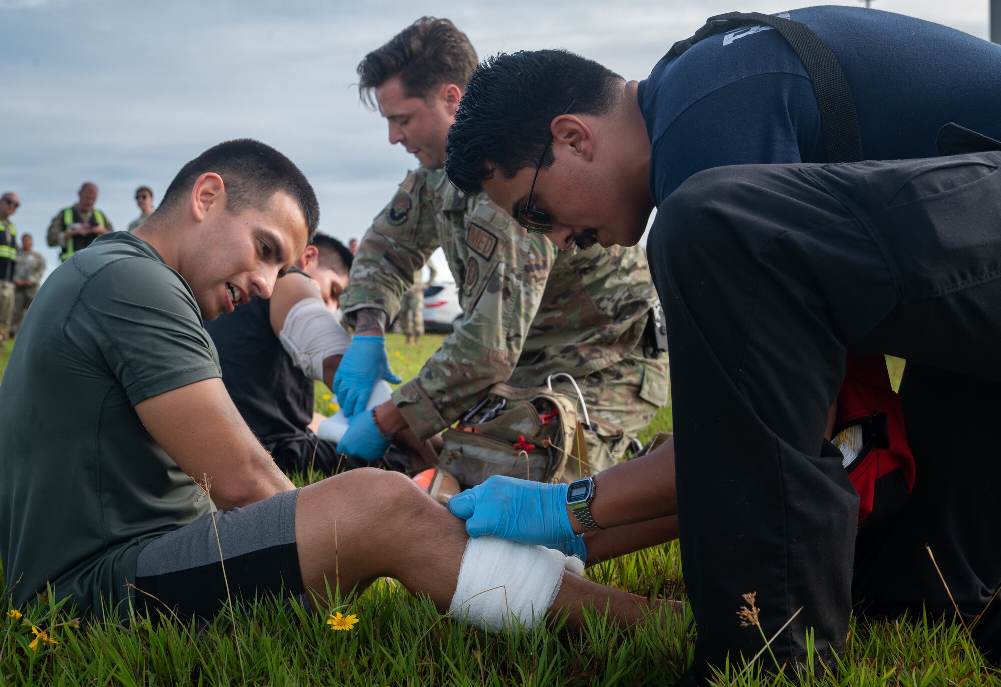 36th Medical Group paramedics treat simulated injured passengers during a major accident response exercise (MARE) for Slingstone 24-4 at Andersen AFB, Guam, Oct. 22, 2024. The MARE allows first responders to hone the skills needed should a real accident happen. This scenario included a simulated plane fire and passengers scattered around with various injuries, something that would be possible during a real world attack or accident. (U.S. Air Force photo by Staff Sgt. Pedro Tenorio)