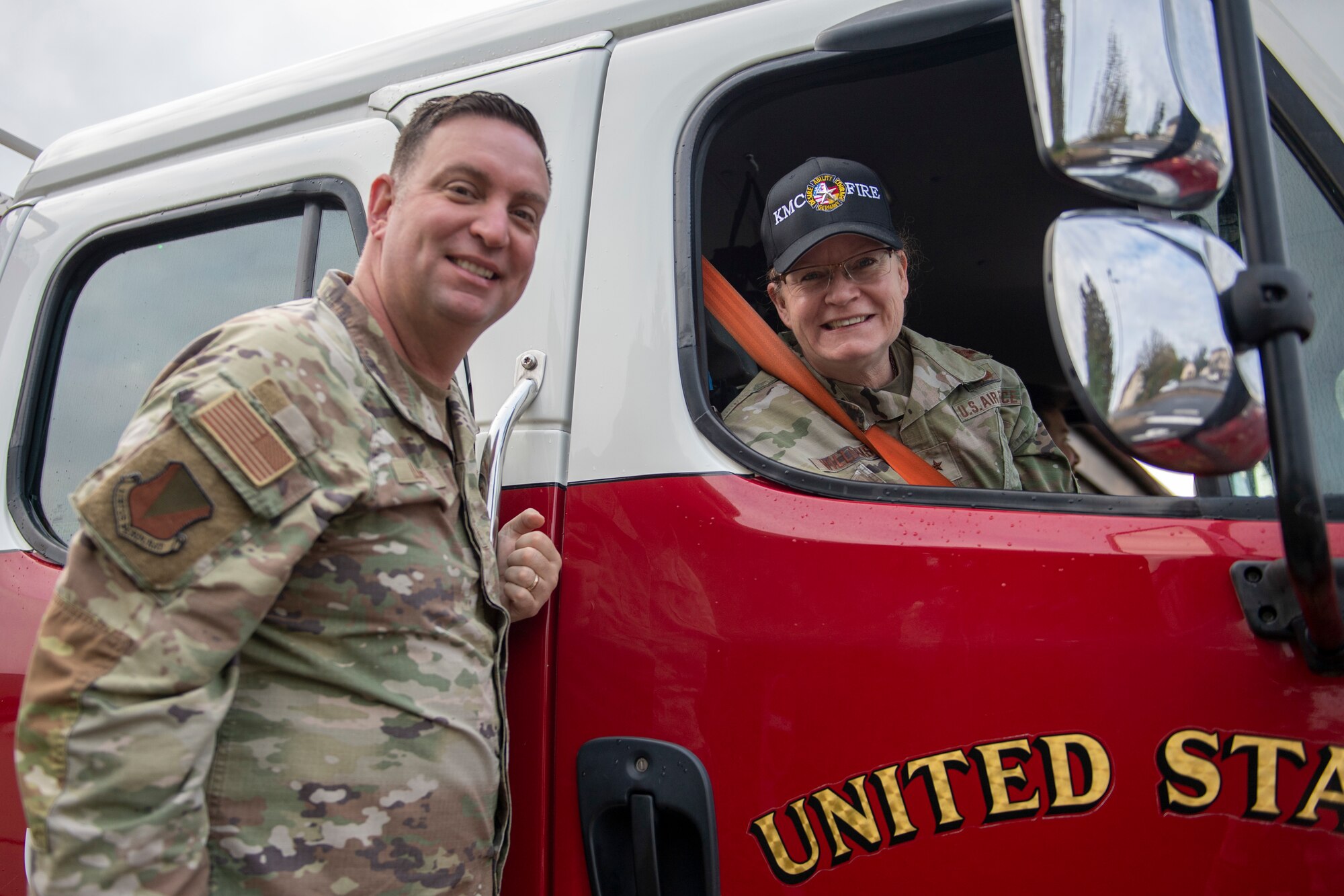 The Commander and Command Chief pose next to a firetruck.