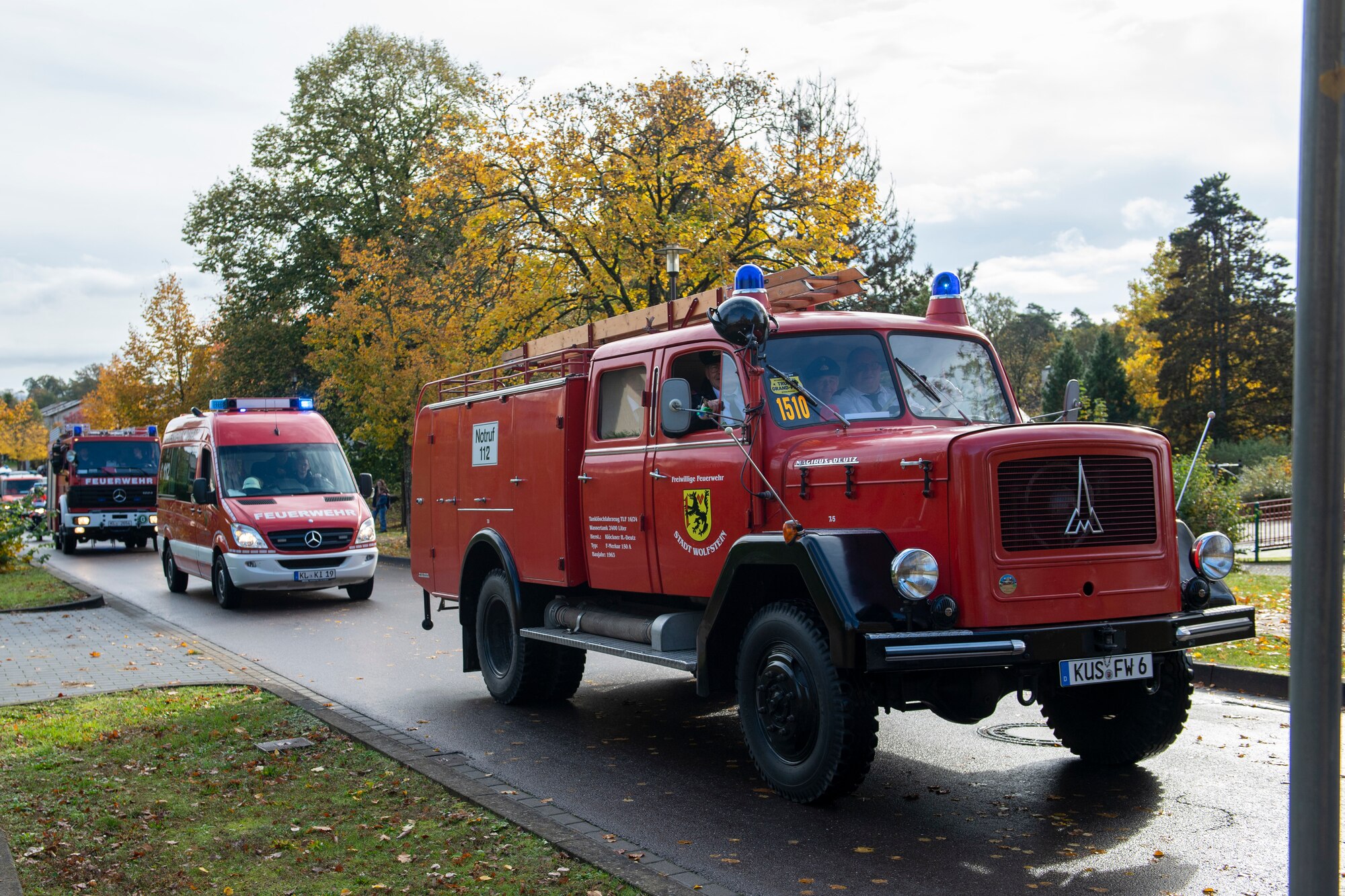 Fire trucks drive through base housing.
