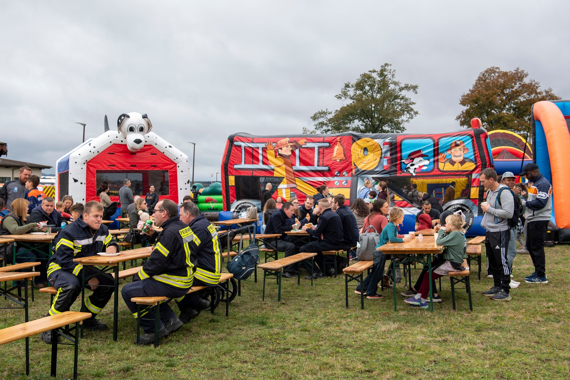 People sit at tables and eat at an event.